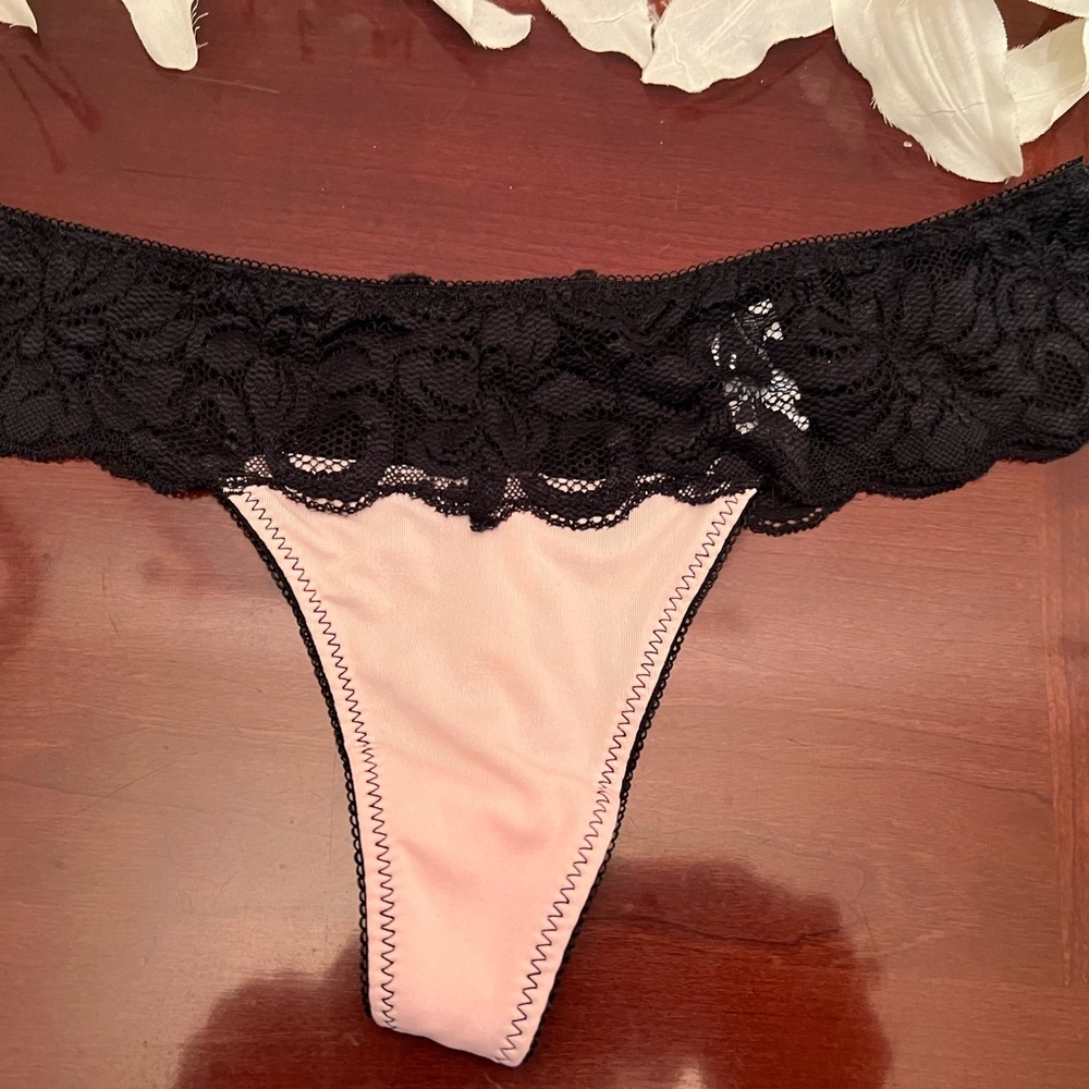 Pink and black lace Thong Panties there’s a bow in the back. Size Large.